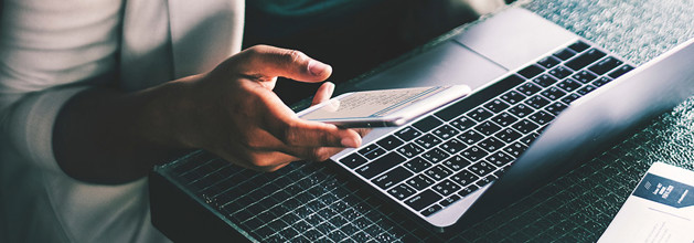 woman on mobile and laptop