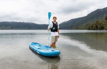 Person in a lifejacket with a paddle board