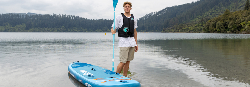 Person in a lifejacket with a paddle board